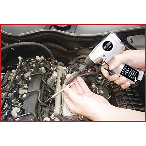 Eine Person schraubt mit einem Druckluftschrauber an einem Motor. Der Schrauber und Zündkerzen sind im Fokus.